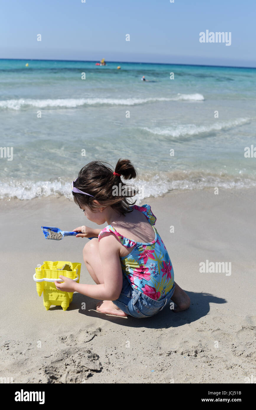 Playing on a sandy beach, Menorca, Spain Stock Photo