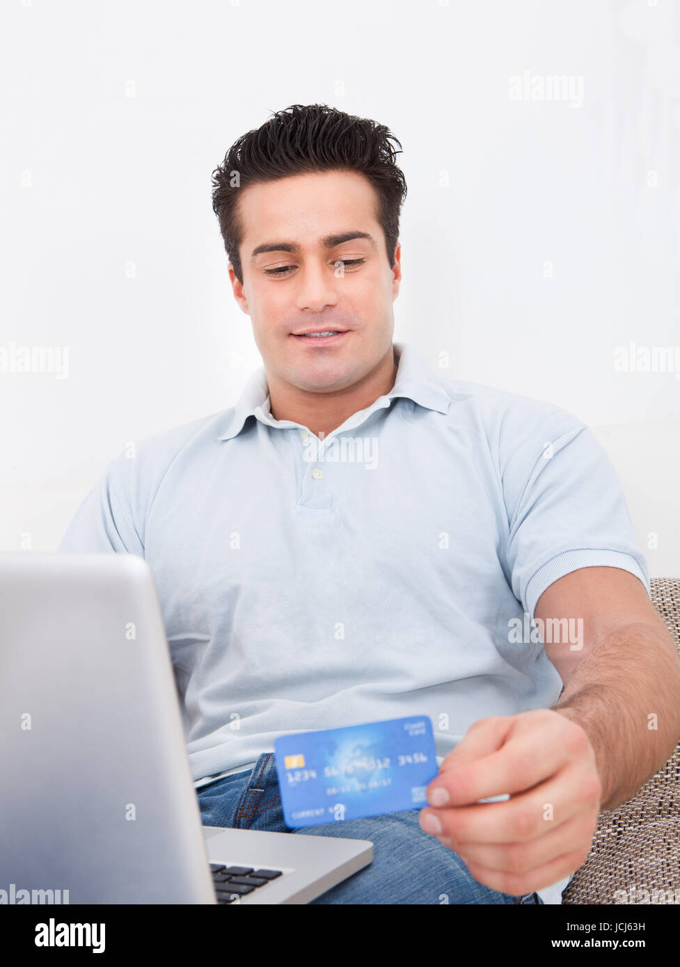 Happy Young Man Shopping Online Using Laptop And Credit Card Stock ...