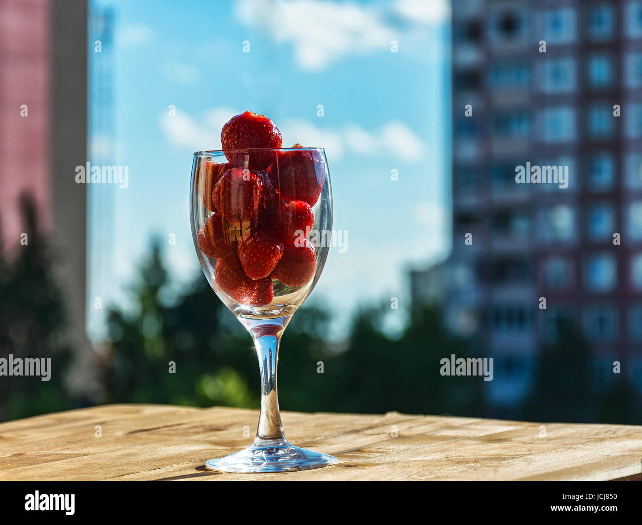 Strawberries in a glass against the blue sky Stock Photo - Alamy