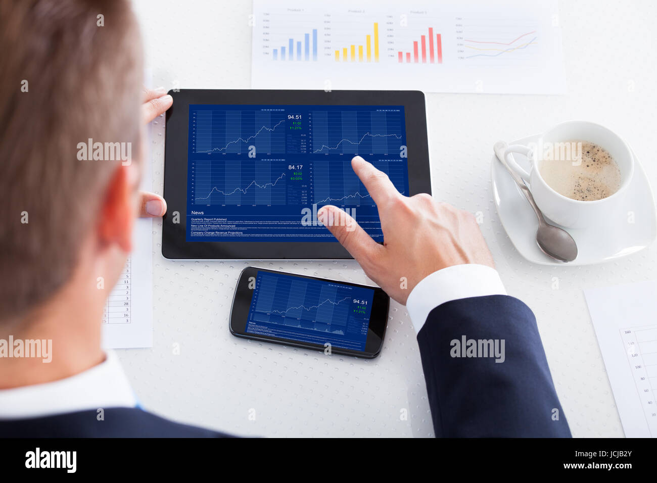 Businessman Analyzing Graph On Digital Tablet In Office Stock Photo - Alamy