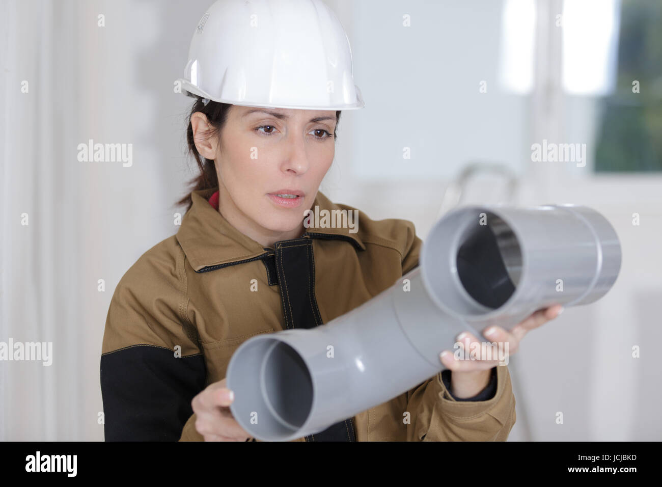 female plumber with pvc sewage pipes Stock Photo Alamy