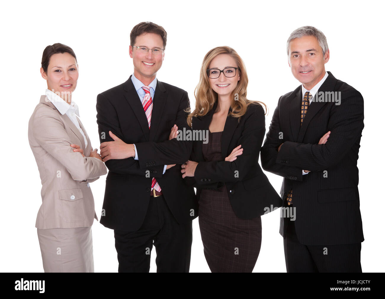 Smiling group of stylish business professionals standing in a row with ...