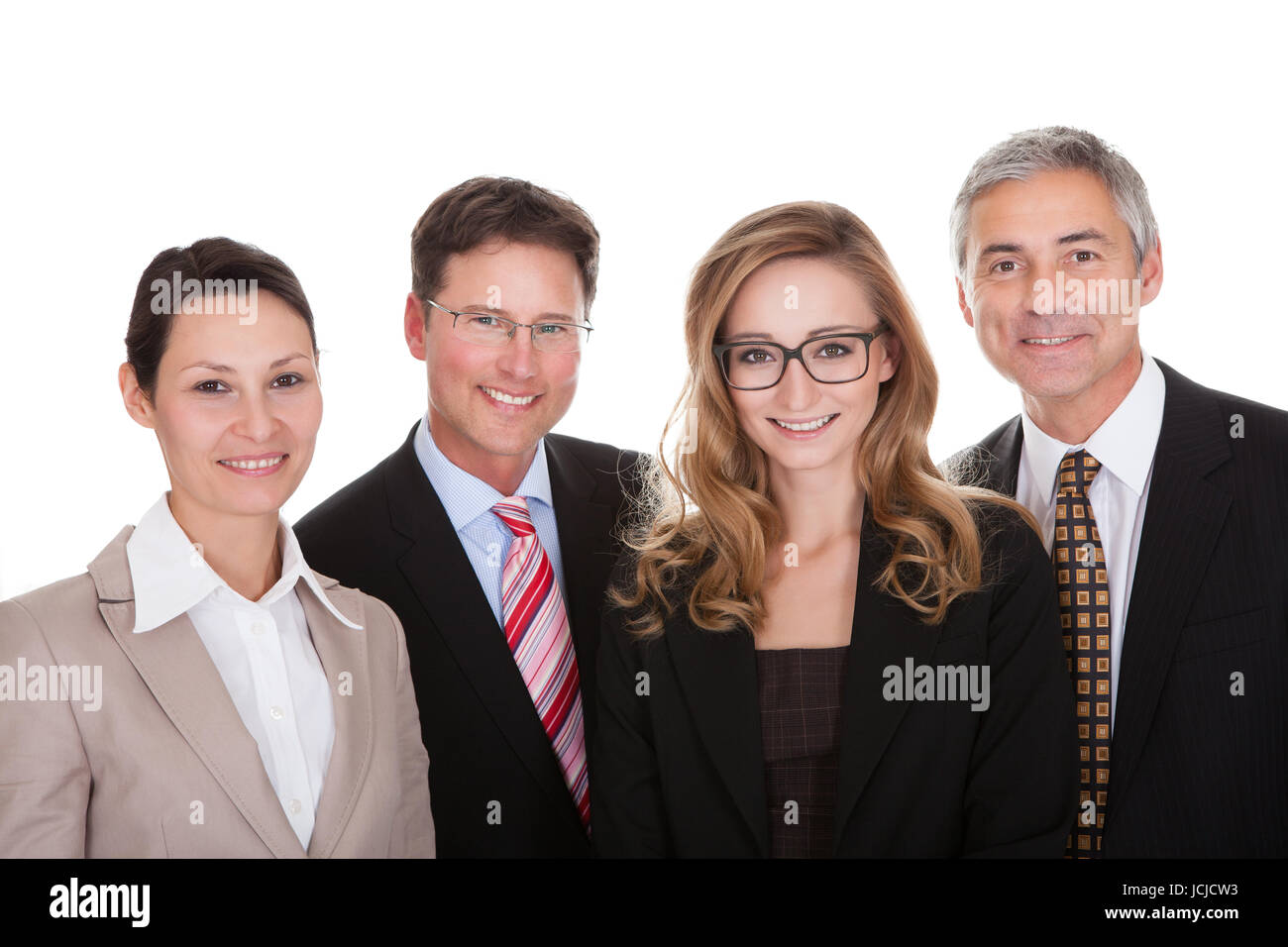 Smiling group of stylish business professionals standing in a row with ...