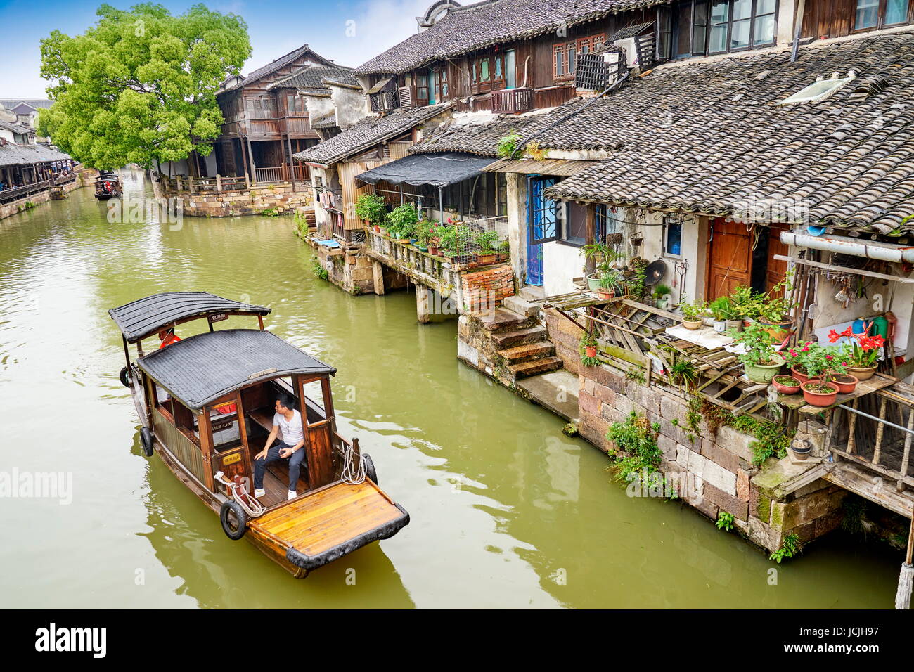 Traditional wooden chinese boat on the Wuzhen canal, Zhejiang province, China Stock Photo