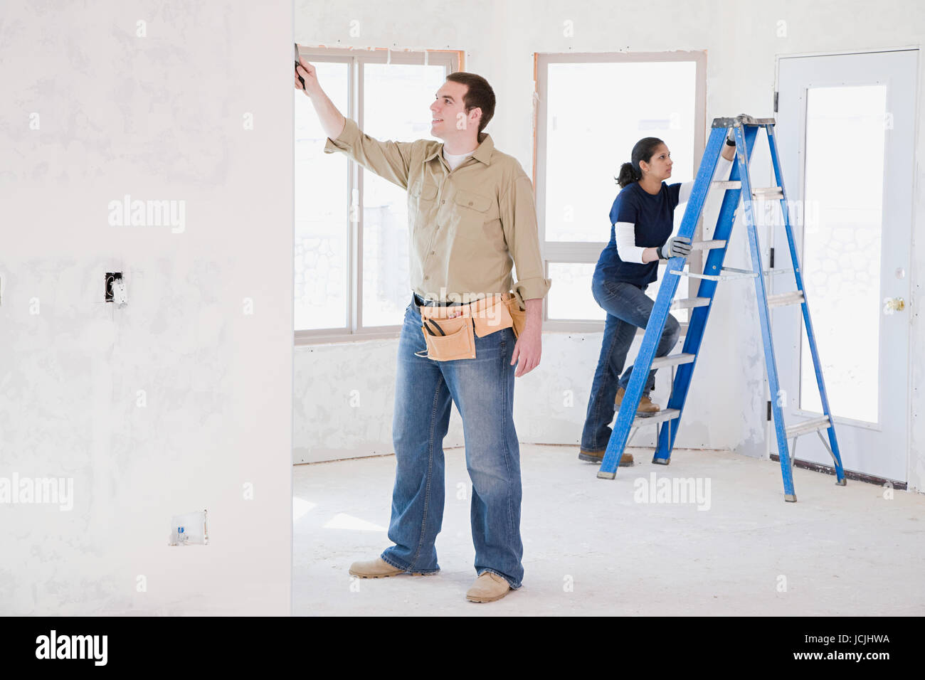 A couple doing building work Stock Photo - Alamy