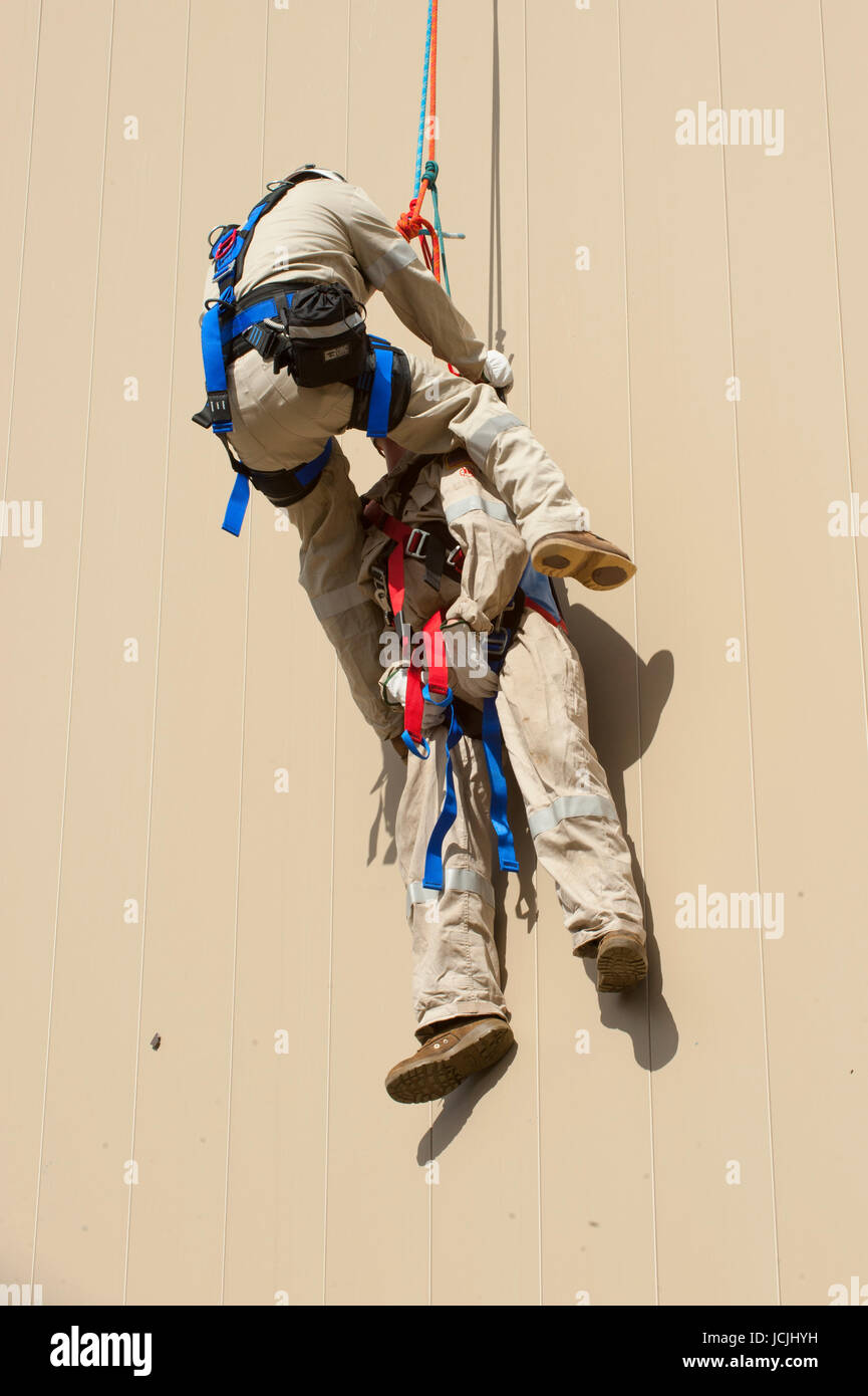 Crews practice high angle rescue at a public training facility at an industrial site in Oregon using ropes, litters and rappelling techniques. Stock Photo