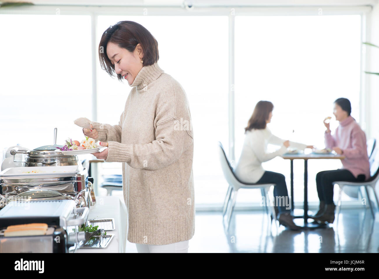 Middle aged women at buffet during vacation Stock Photo