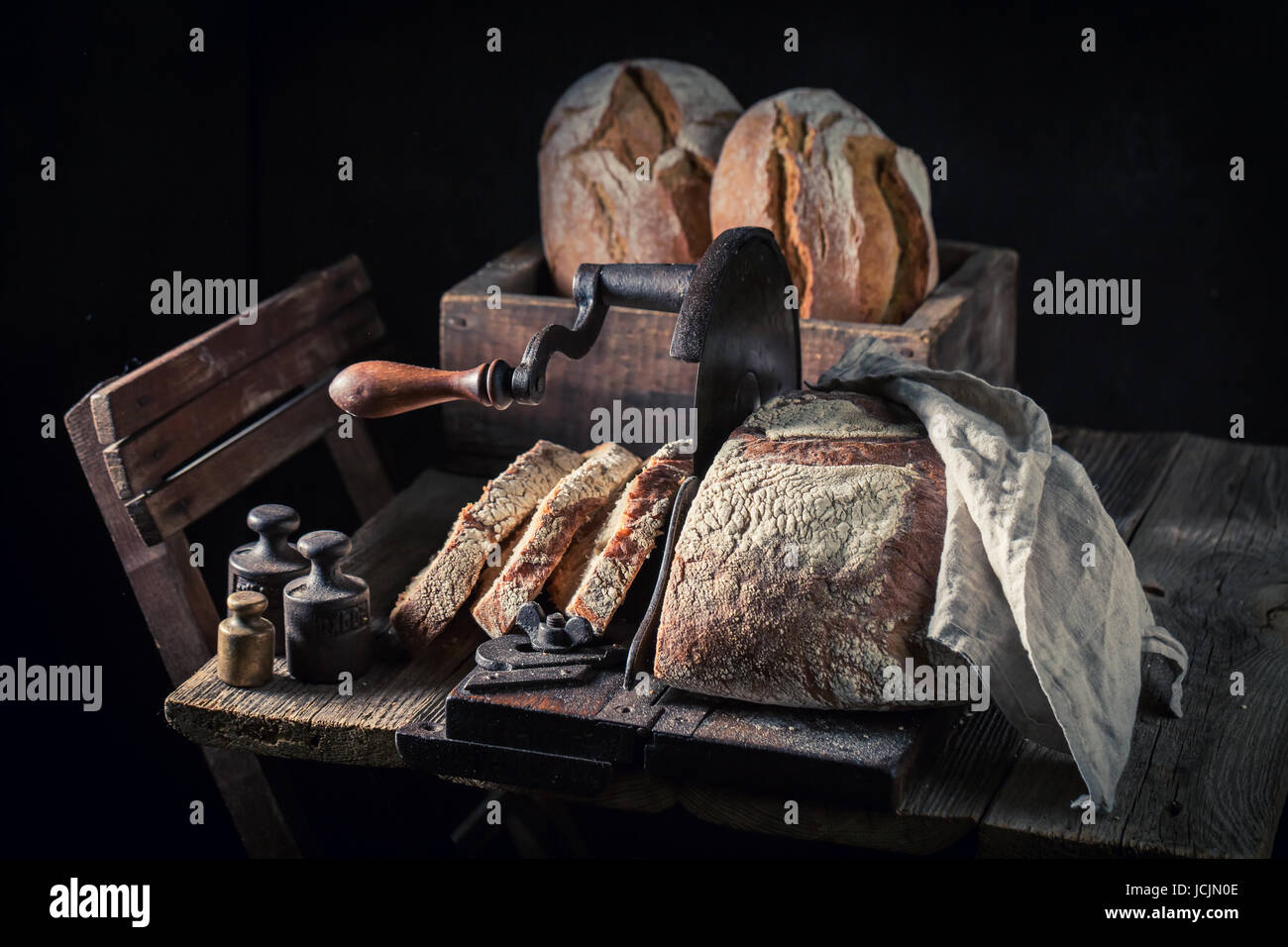 https://c8.alamy.com/comp/JCJN0E/big-loaf-of-bread-on-old-wooden-table-JCJN0E.jpg