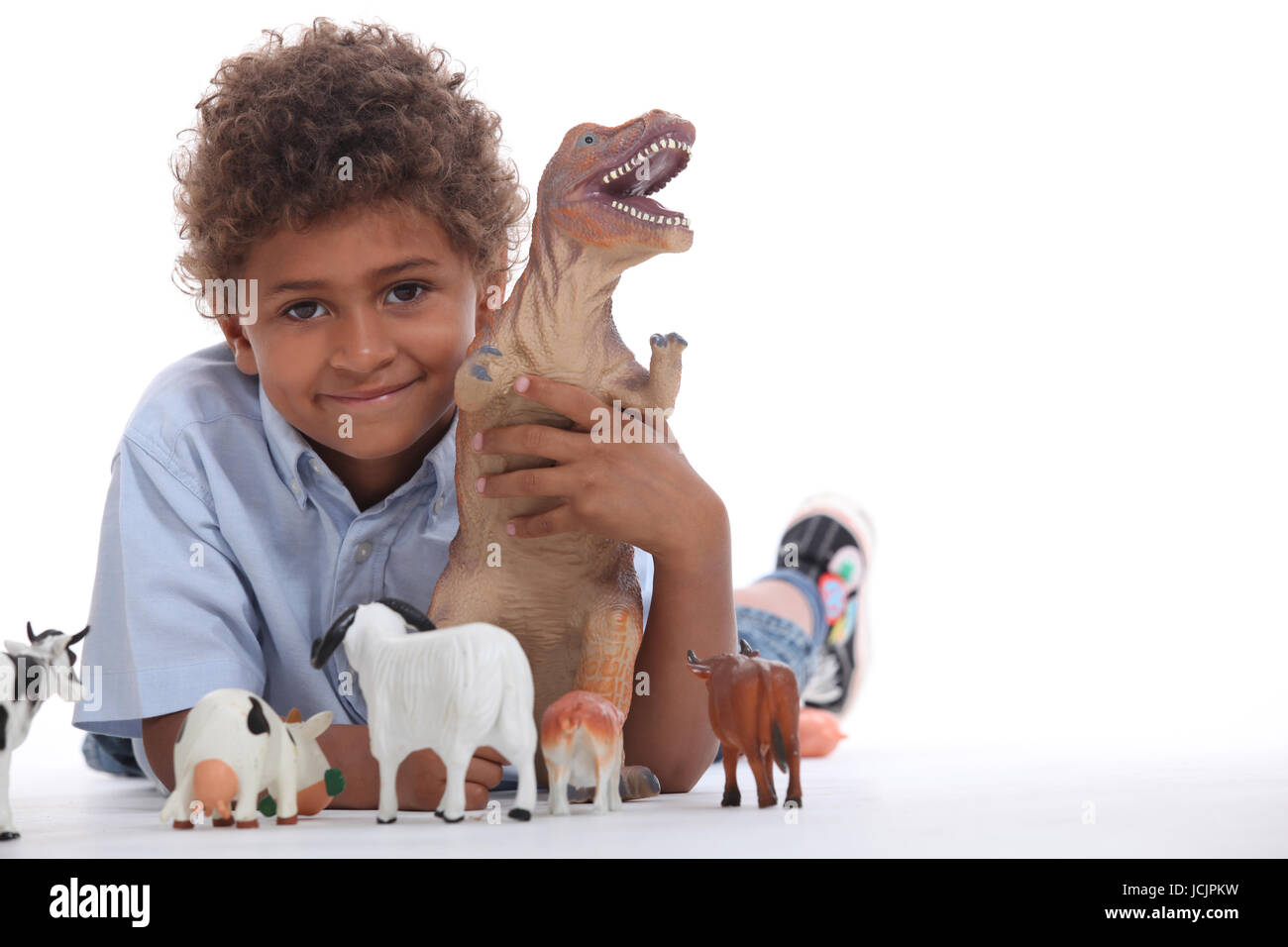 Little boy playing with toys Stock Photo - Alamy