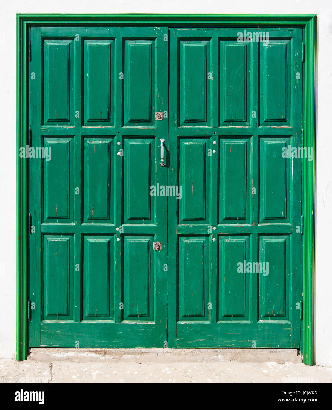 green,canary,slightly weathered double door Stock Photo
