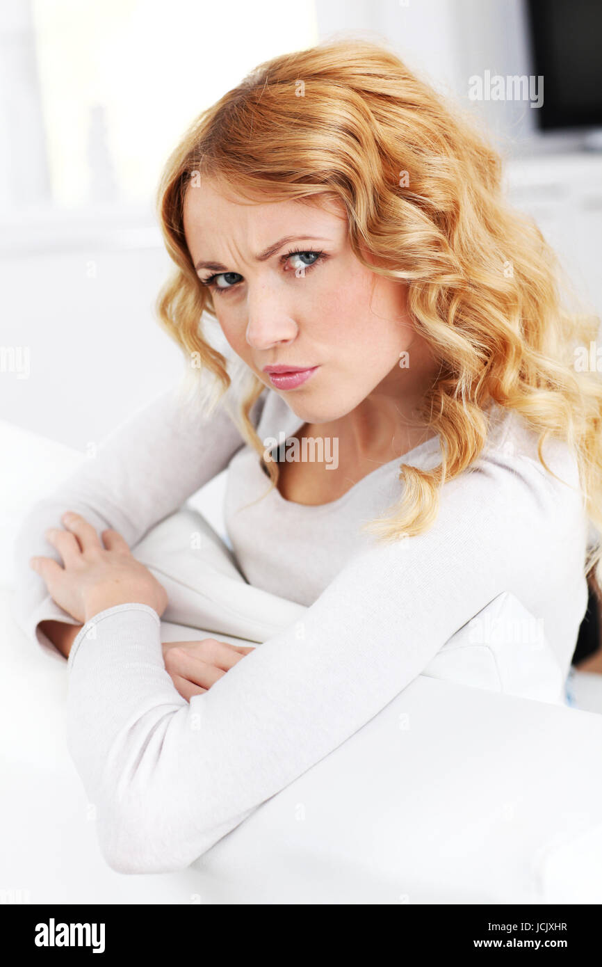 Portrait of beautiful woman sitting in sofa Stock Photo - Alamy
