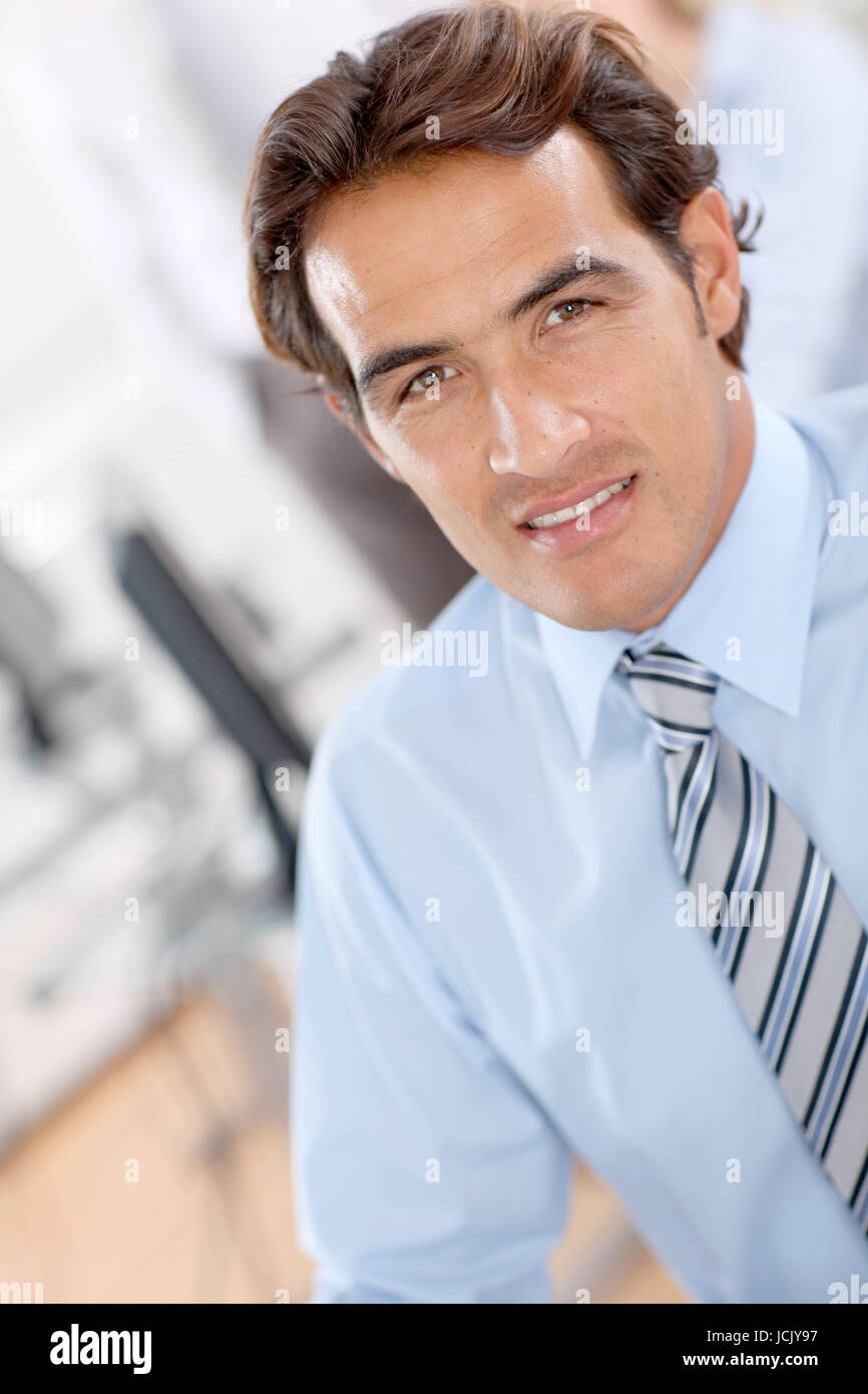 Portrait of smiling businessman in office Stock Photo - Alamy