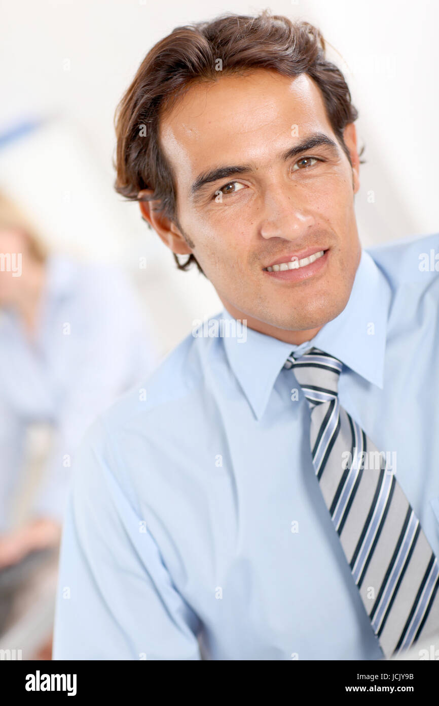 Portrait of smiling businessman in office Stock Photo - Alamy