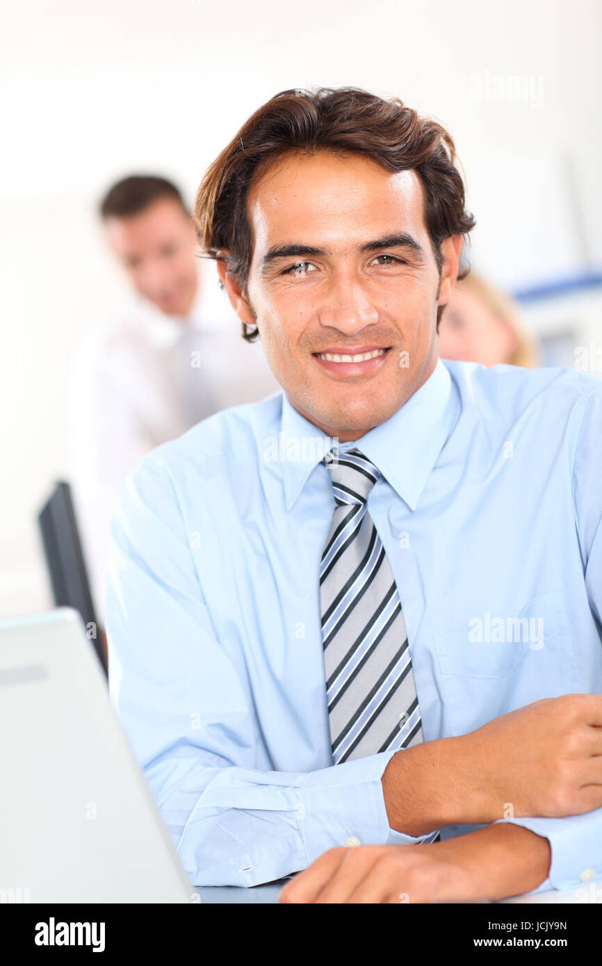 Portrait of smiling businessman in office Stock Photo - Alamy