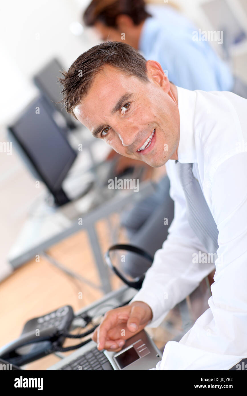 Portrait of smiling businessman in office Stock Photo - Alamy