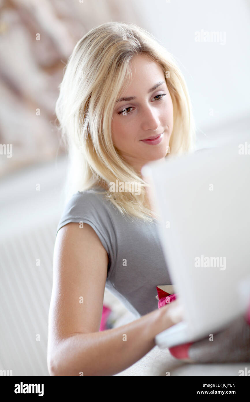 Girl laying in sofa with laptop computer Stock Photo - Alamy