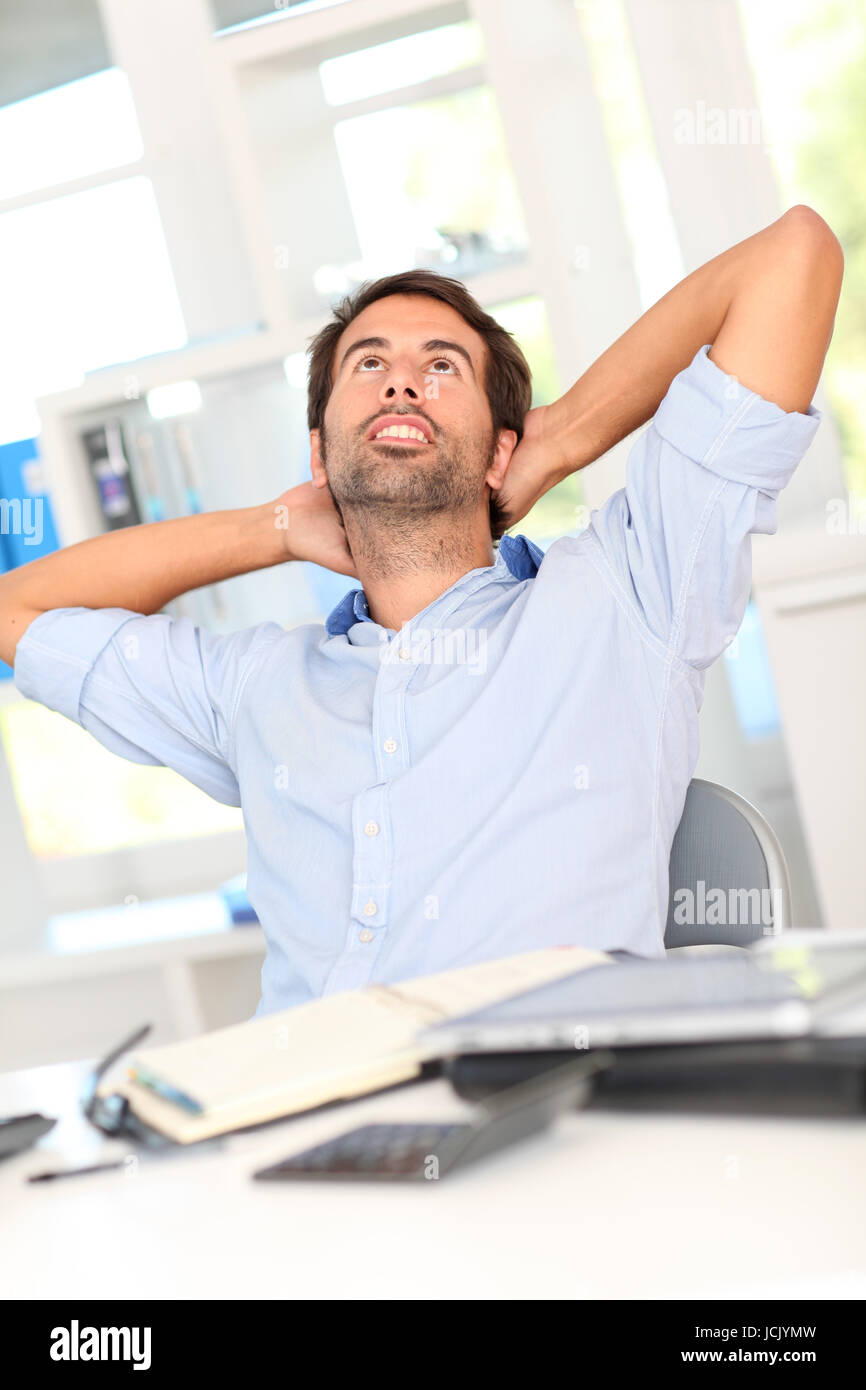 Relaxed businessman in office Stock Photo - Alamy