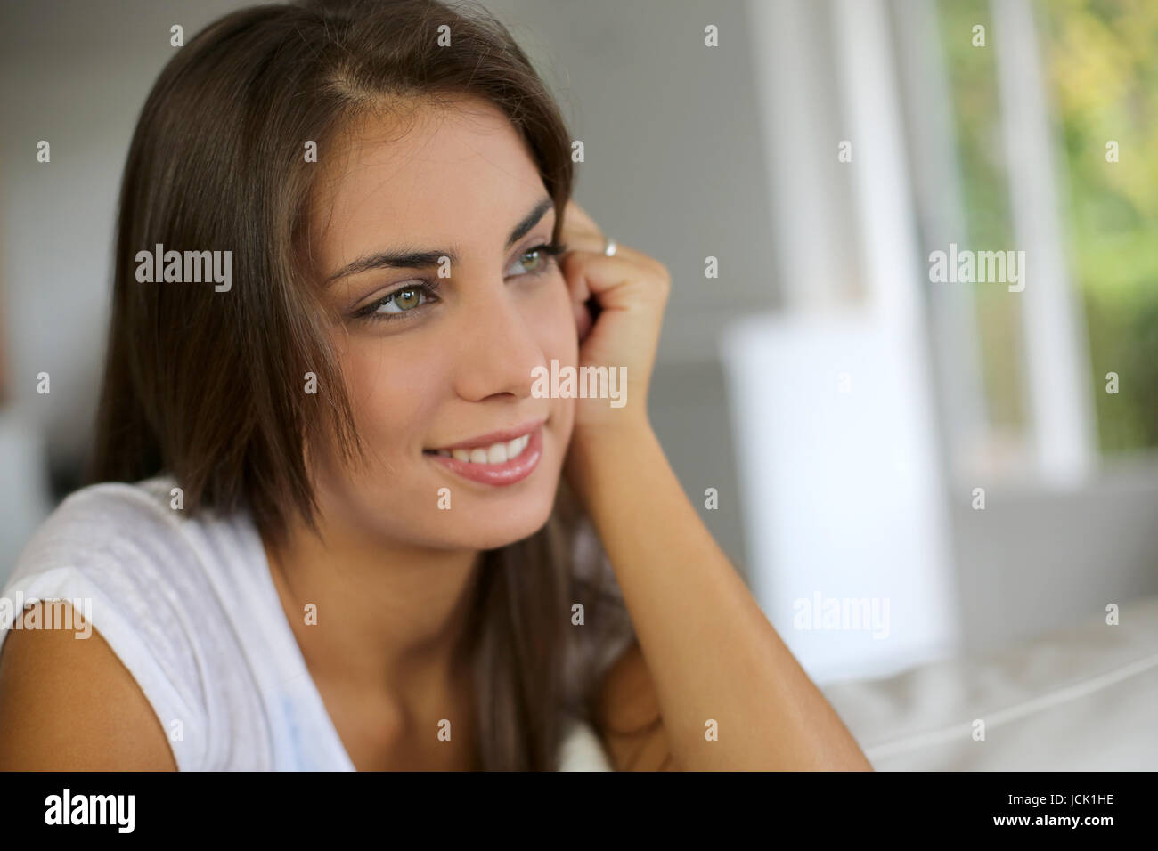 Portrait of beautiful girl sitting in sofa Stock Photo - Alamy