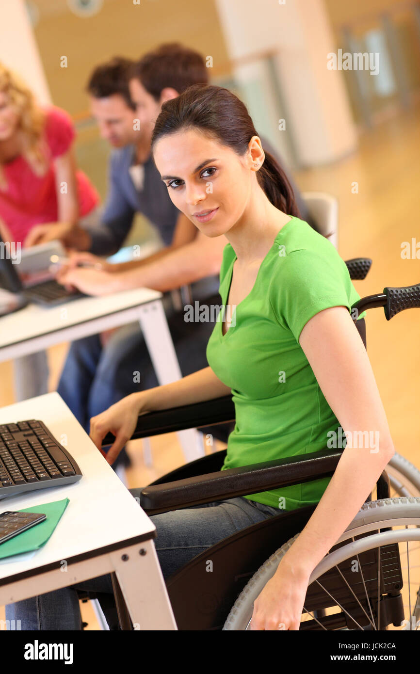 Young woman in wheelchair working in office Stock Photo Alamy