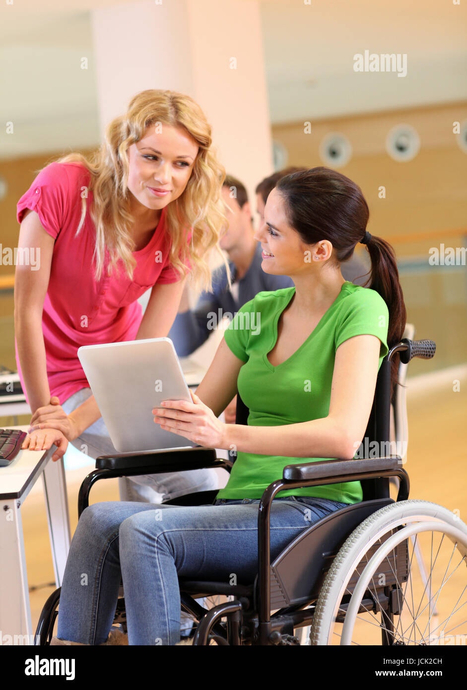 Handicapped person at work with electronic tablet Stock Photo - Alamy