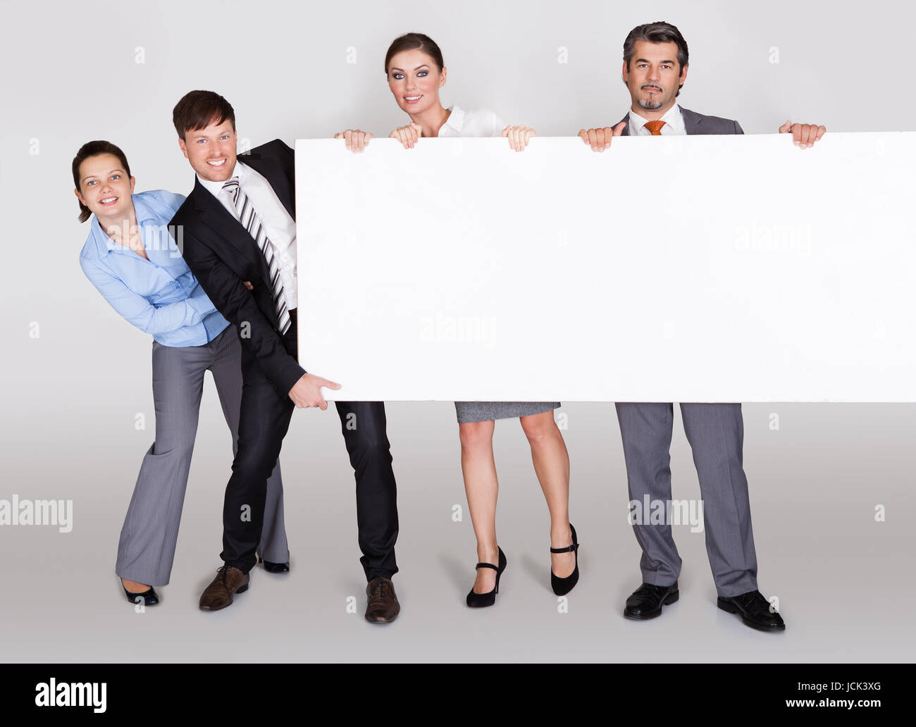 Group Of Businesspeople In A Row Holding Placard Stock Photo Alamy Group Of Businesspeople In A Row Holding Placard Stock Photo Alamy