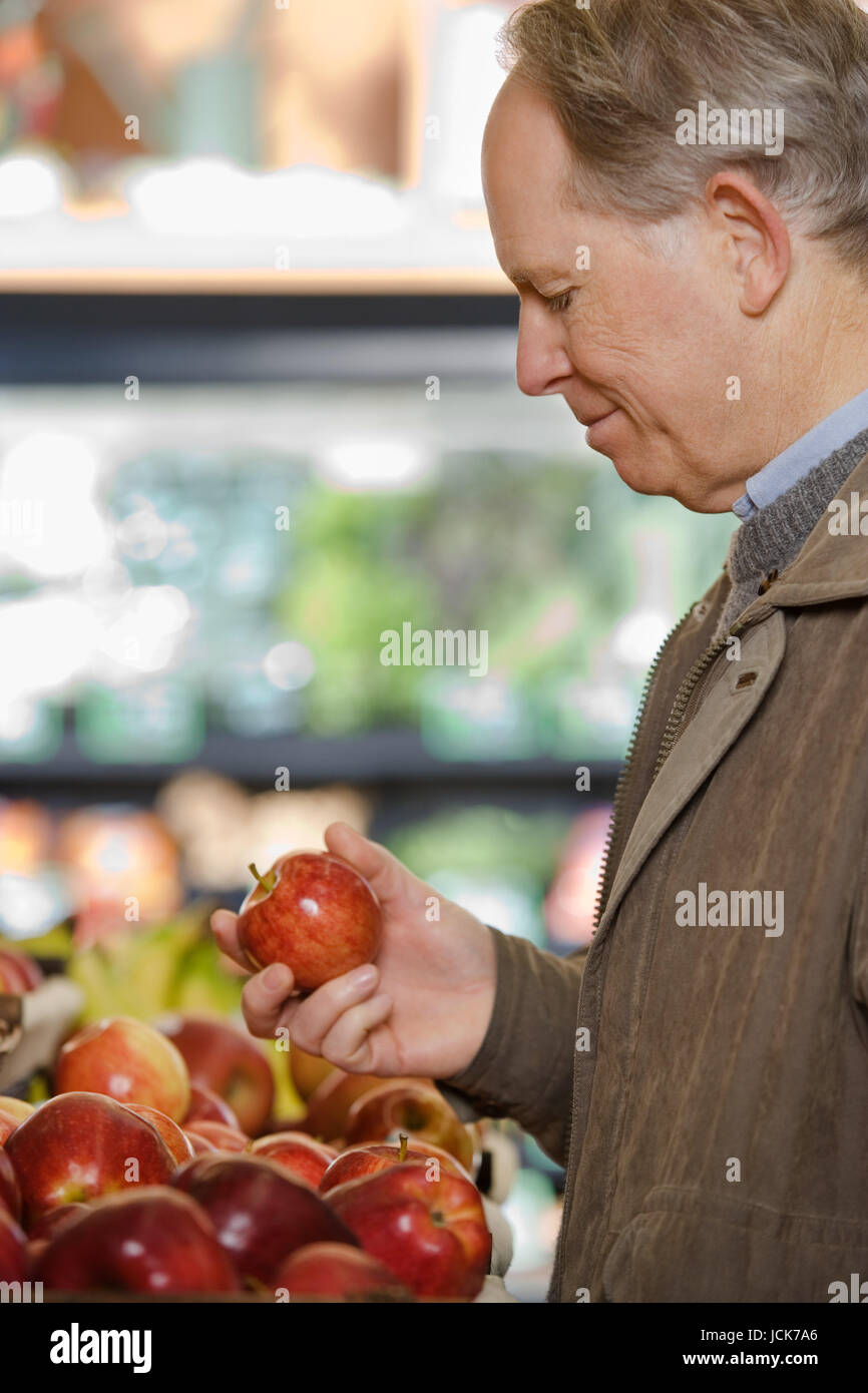 A man holding an apple Stock Photo - Alamy