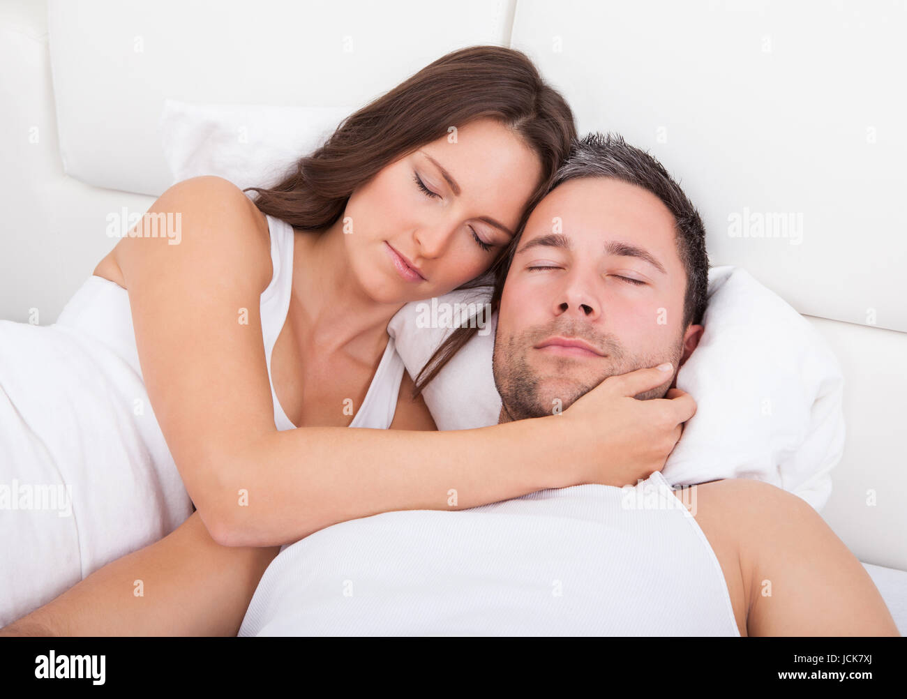 Young Couple Sleeping Side By Side On Bed Stock Photo Alamy