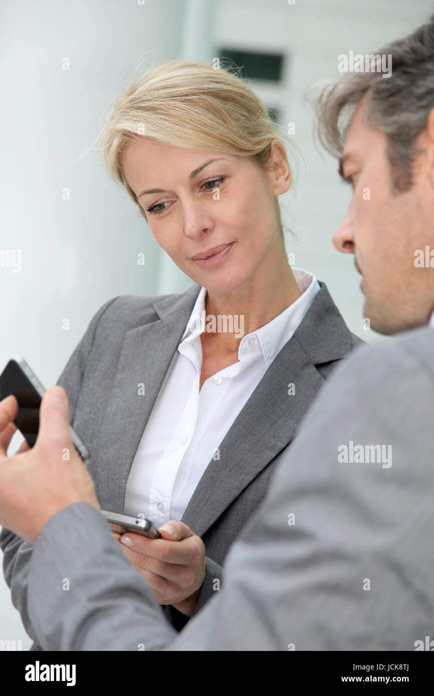 Business people exchanging phone numbers Stock Photo Alamy