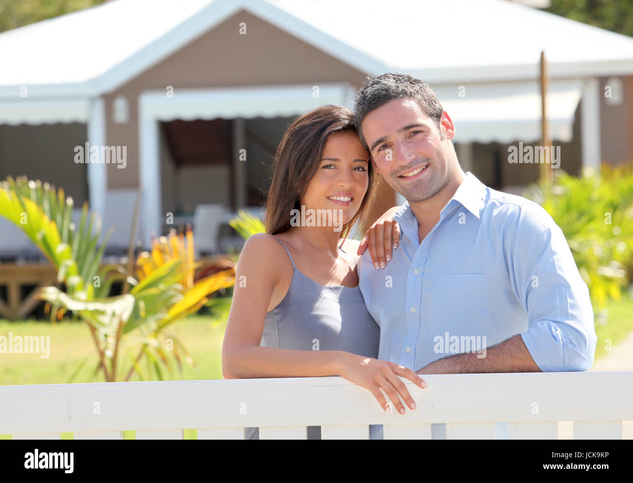 Couple standing in front of new home Stock Photo - Alamy