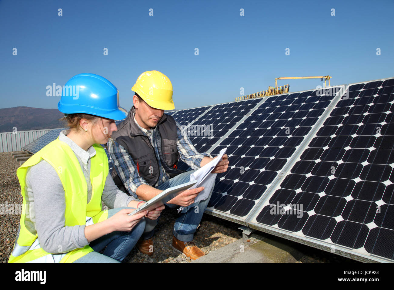 Man showing solar panels technology to student girl Stock Photo