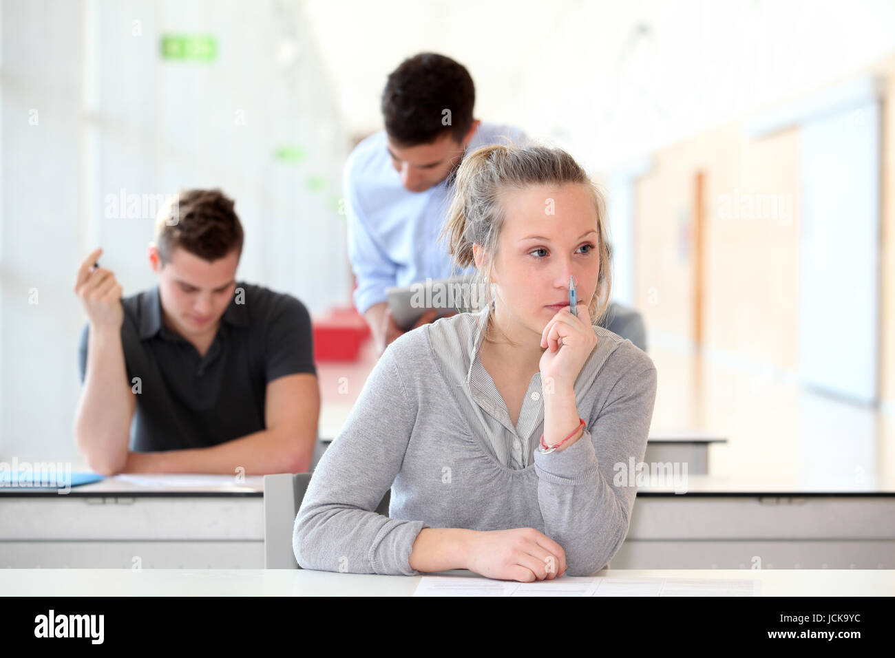 Student passing examination in school classroom Stock Photo - Alamy