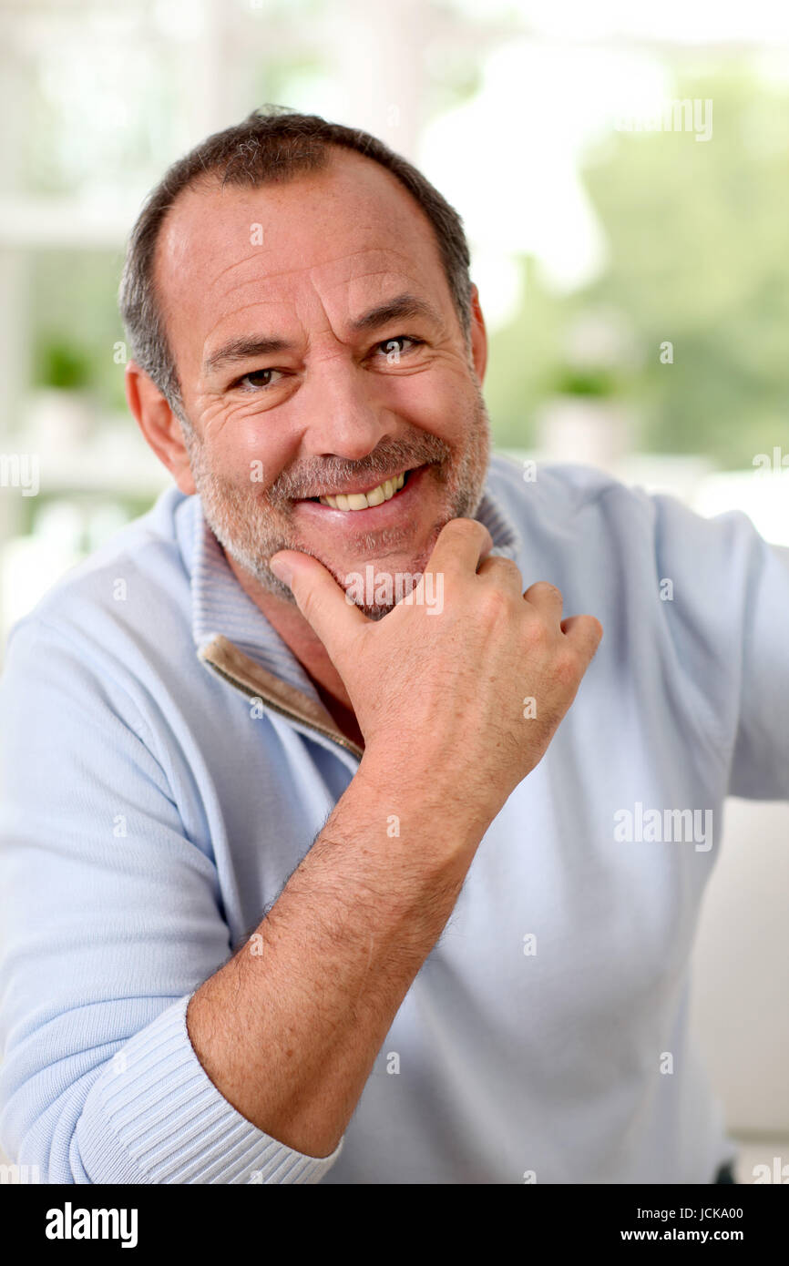 Portrait of senior man sitting in sofa at home Stock Photo - Alamy