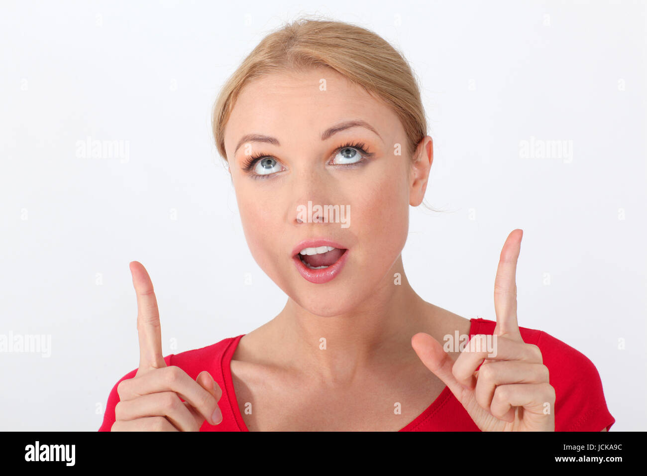 Portrait of woman with red shirt having interrogative look Stock Photo
