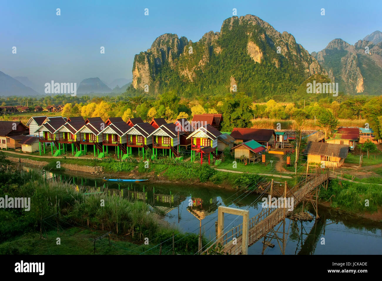 Row of tourist bungalows along Nam Song River in Vang Vieng, Vientiane Province, Laos. Vang Vieng is a popular destination for adventure tourism in a  Stock Photo