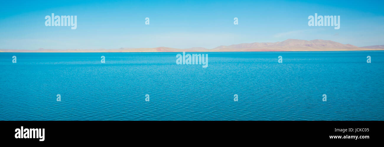 Beautiful blue color lake and yellow mountain scenery in Tibet . Stock Photo