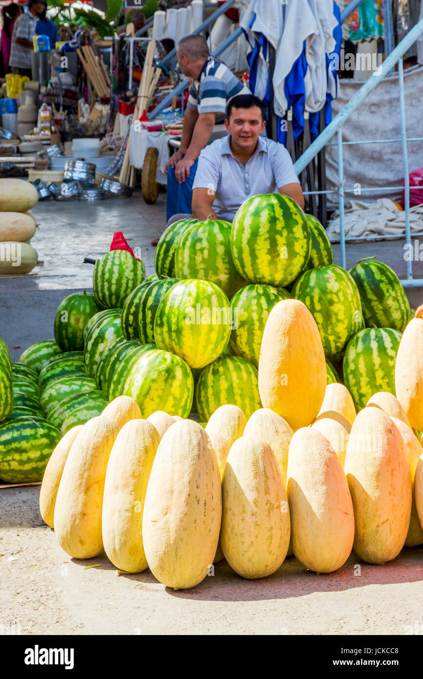 SAMARKAND, UZBEKISTAN - AUGUST 28: Man selling best uzbek watermelons and honey melons at Siab bazaar local market in Samarkand. August 2016 Stock Photo