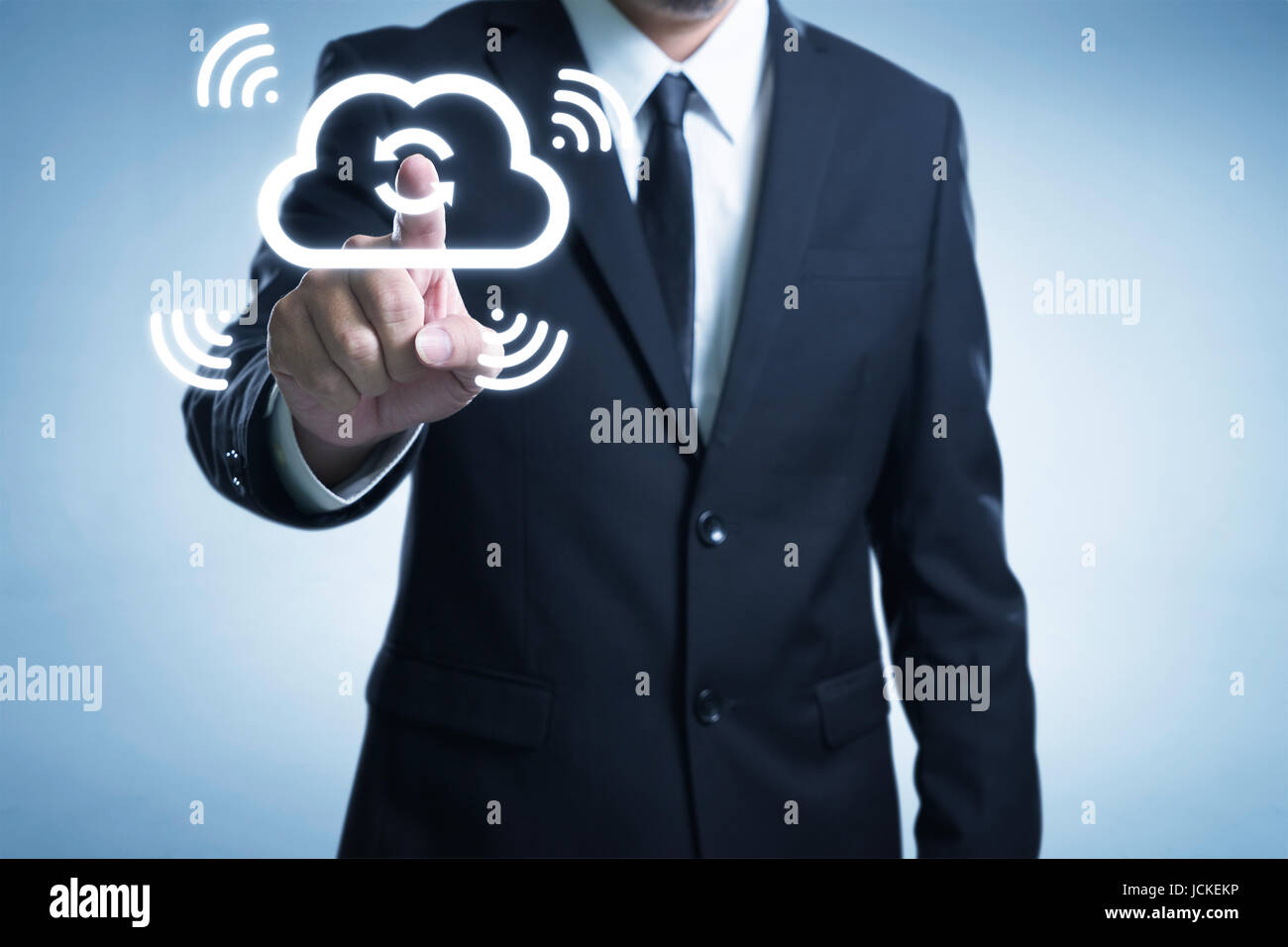 Businessman touch the cloud to sync the data thru wireless internet technologist . Stock Photo