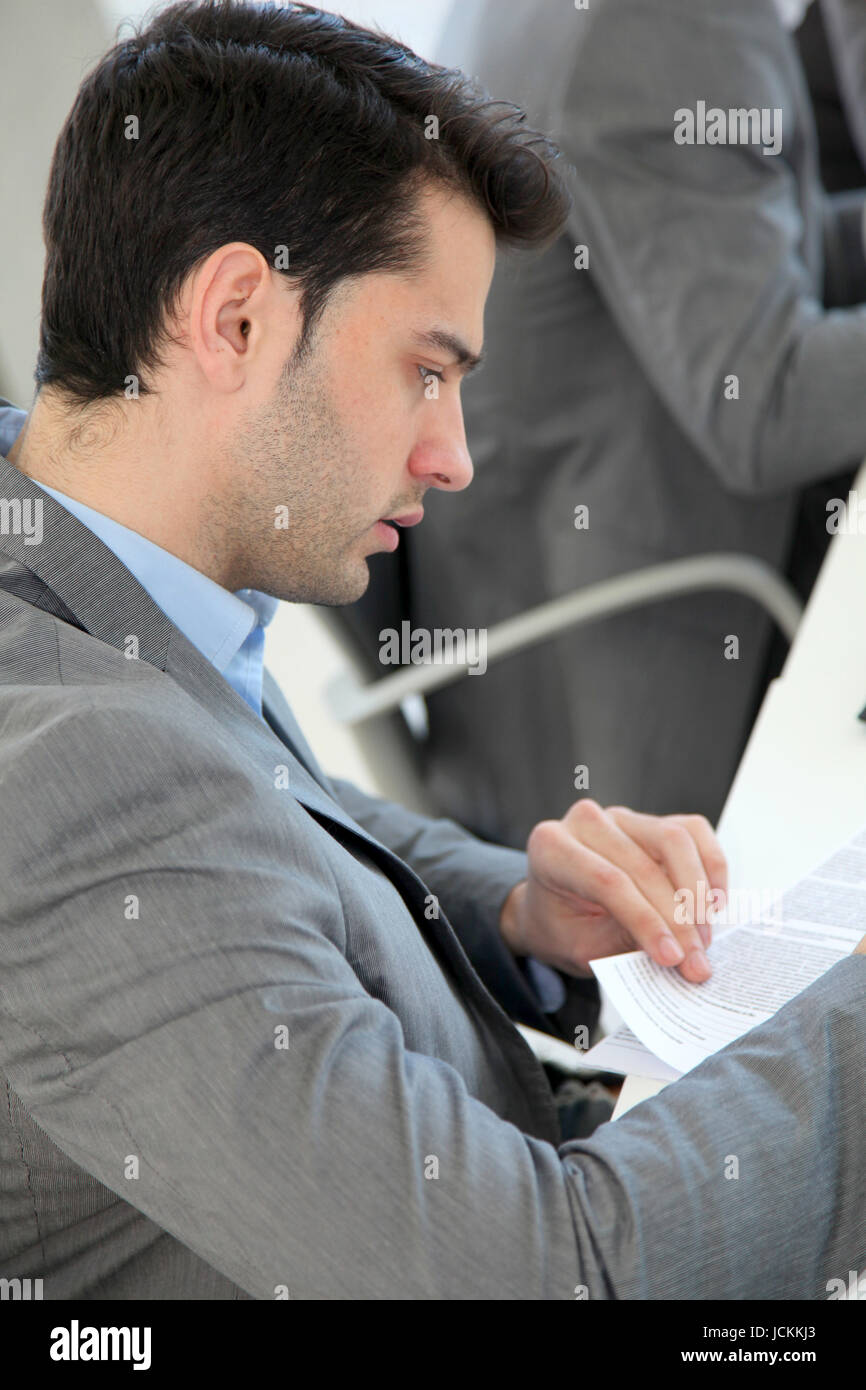 Young man filling in application form Stock Photo - Alamy