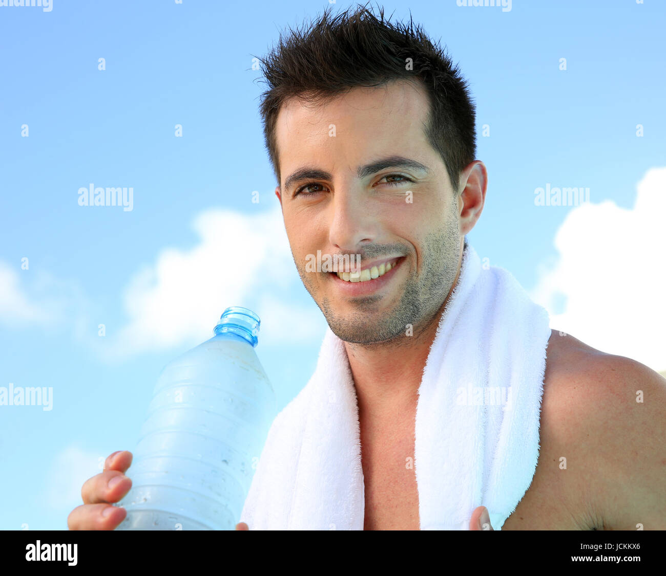 Handsome man drinking water after exercising Stock Photo