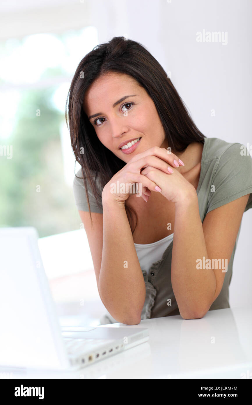 Beautiful young woman working at home on laptop computer Stock Photo ...