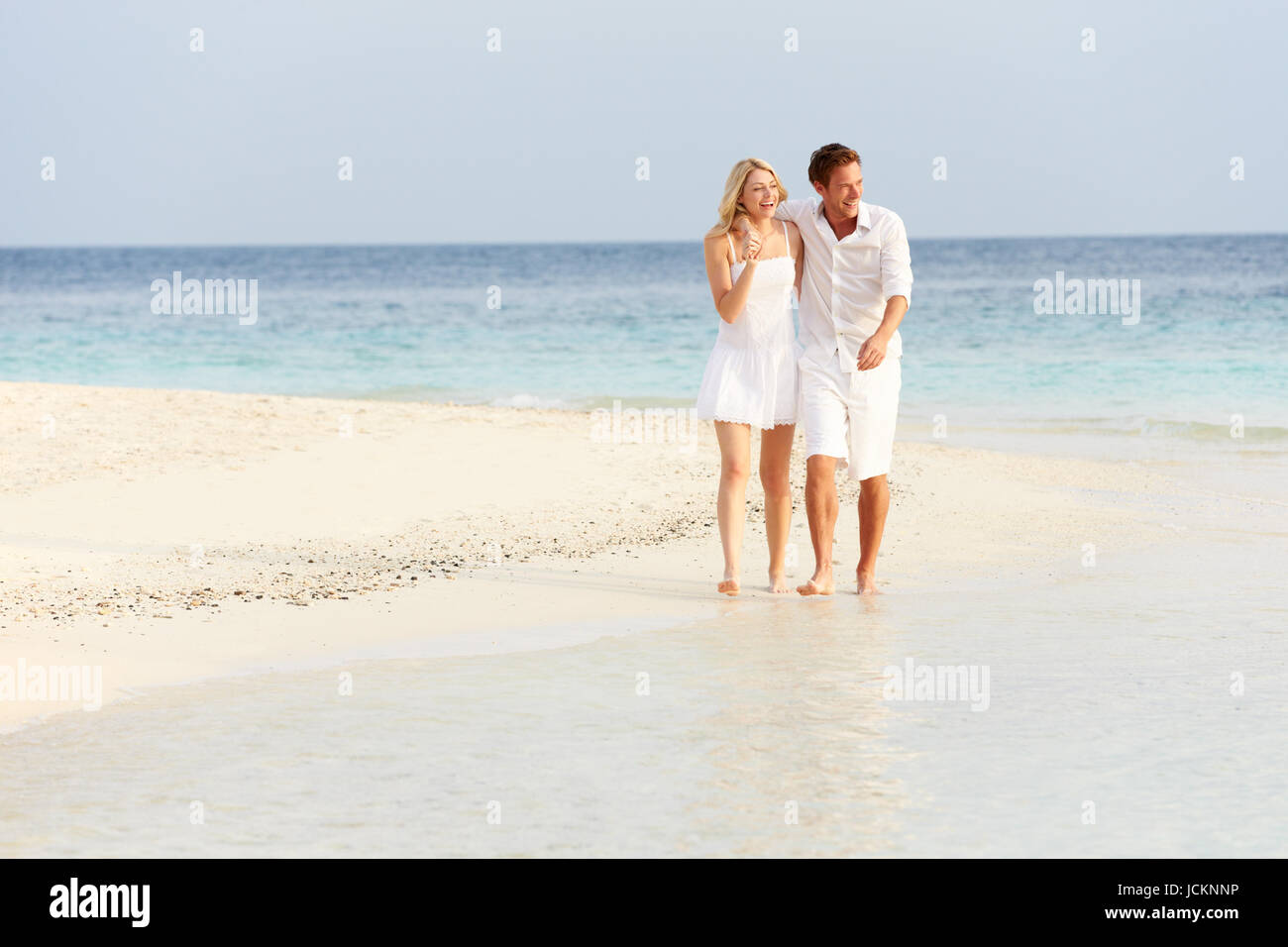Romantic Couple Walking On Beautiful Tropical Beach Stock Photo - Alamy