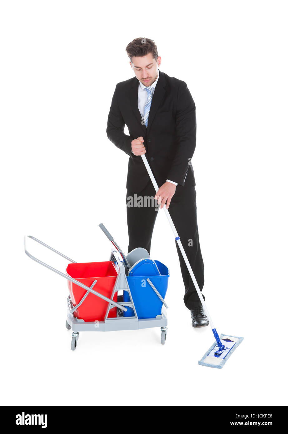 Full length of sad young businessman mopping over white background Stock Photo