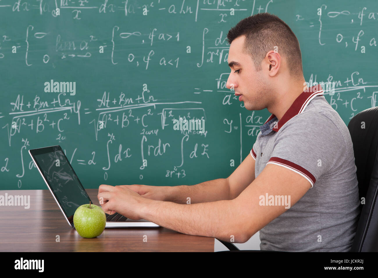 Math Problem Solving Portrait Cropped image of young male student solving math's problem on laptop by ...