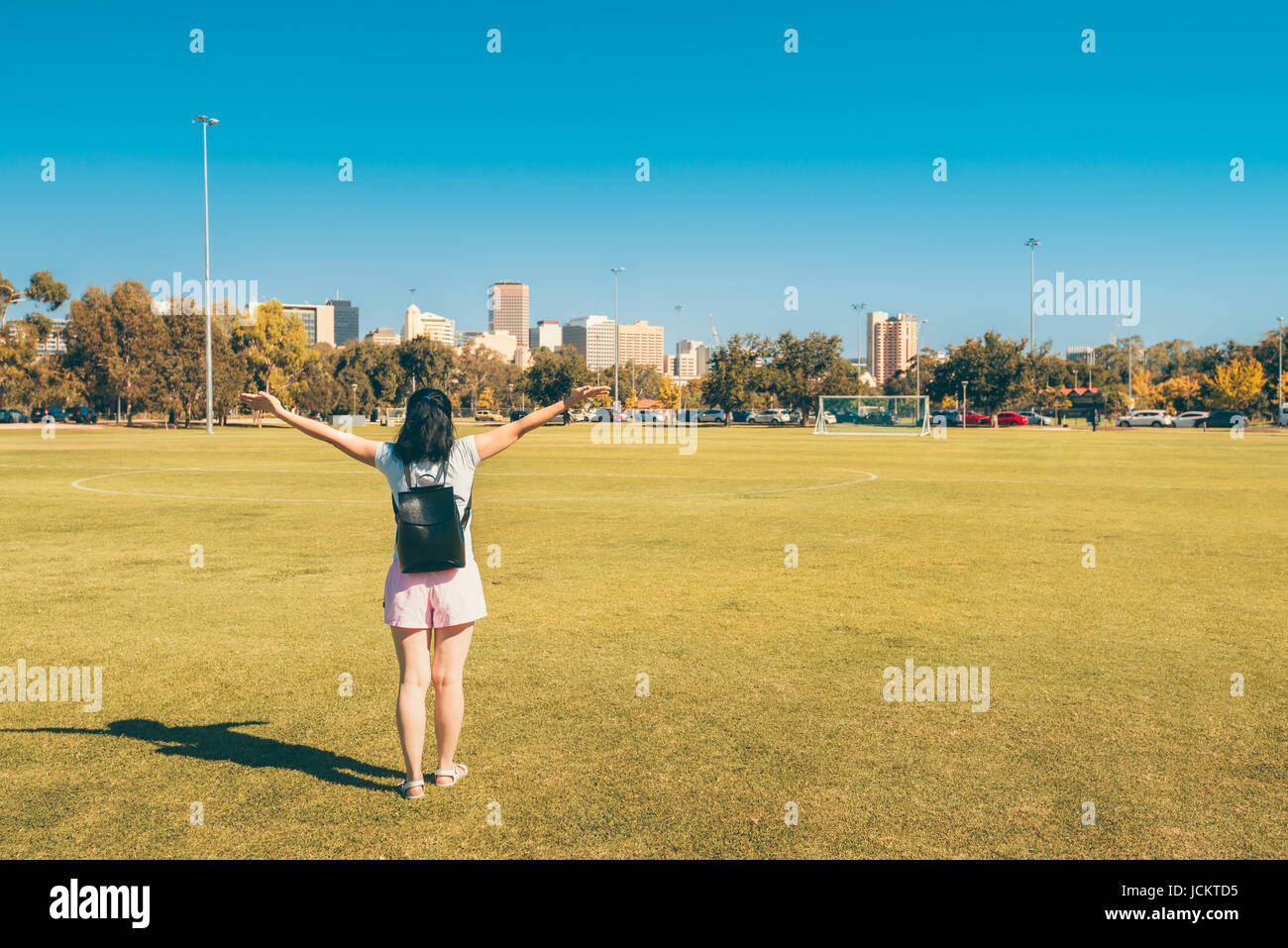 Happy woman looking at Adelaide city with hands up Stock Photo Alamy