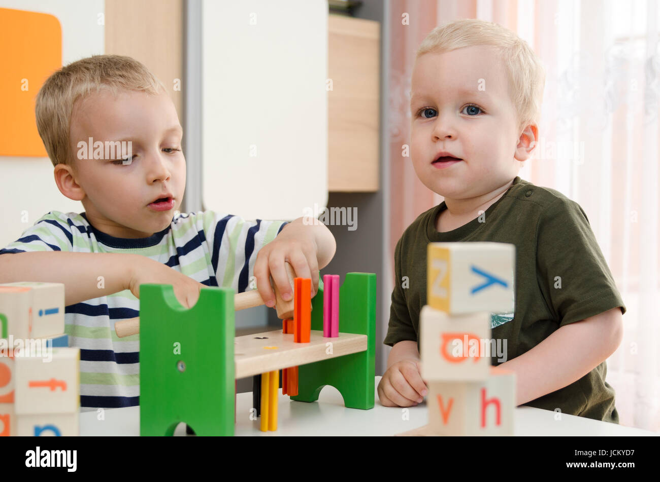 Kids boys playing with toy blocks at home or kindergarten. children kindergarten playing preschool daycare school child colorful concept Stock Photo