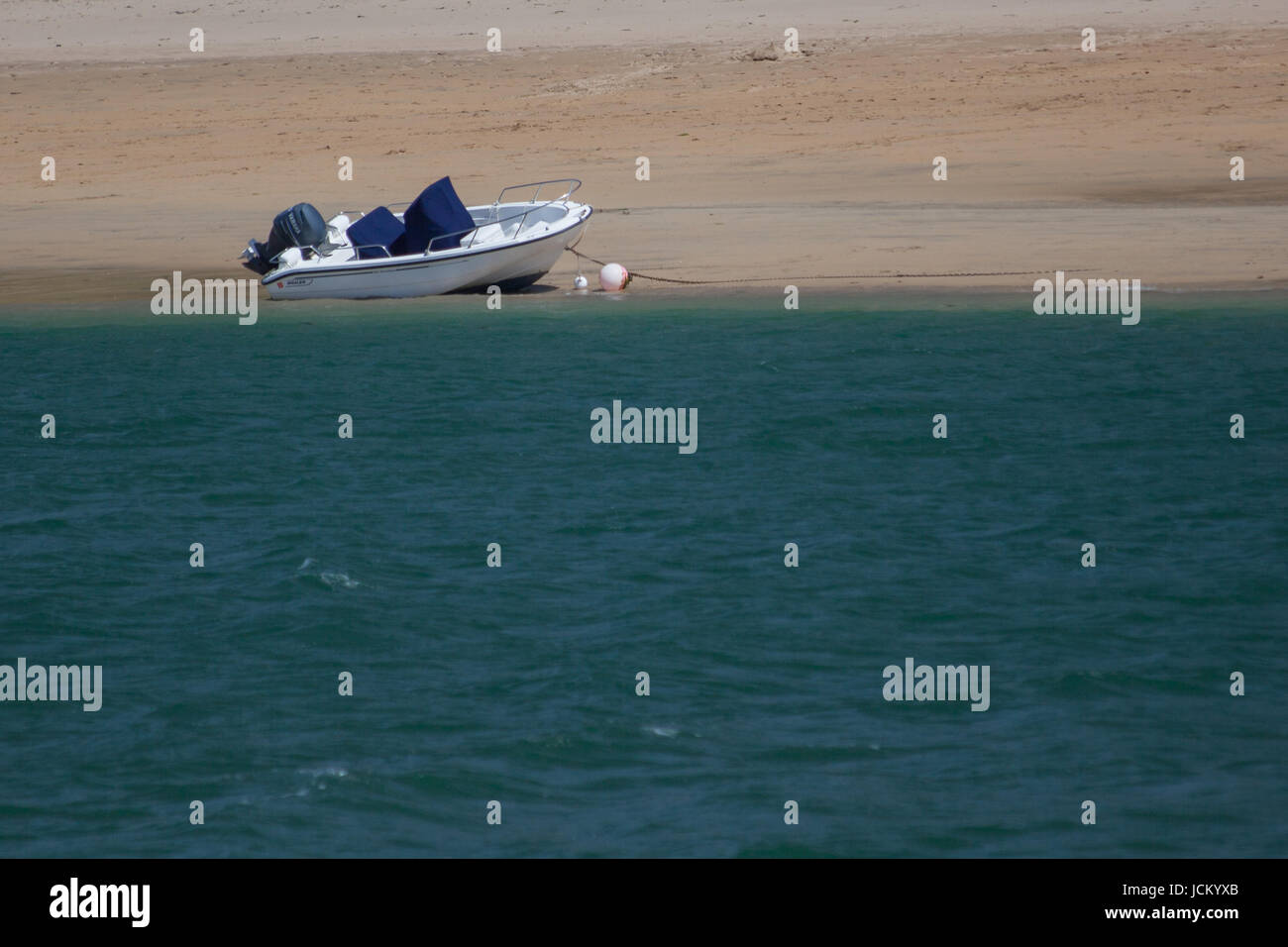 Small Boat Moored on a beach Stock Photo