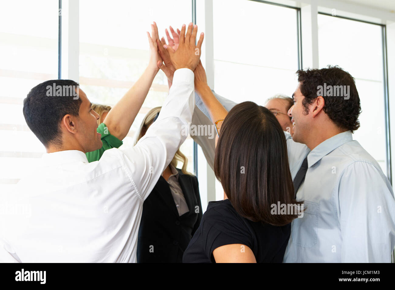 Business Team Giving One Another High Five Stock Photo - Alamy