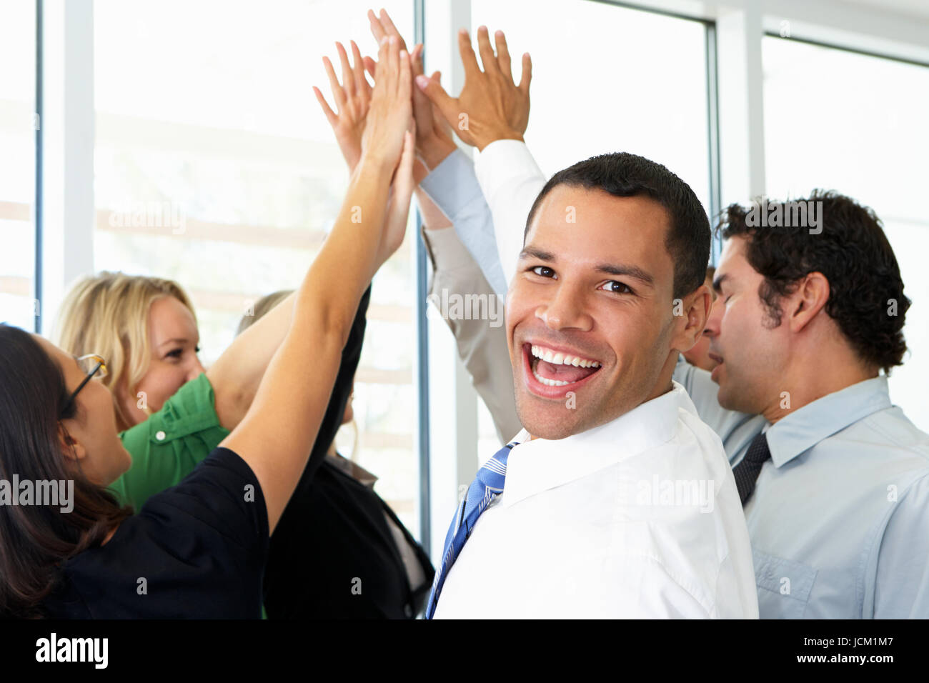 Business Team Giving One Another High Five Stock Photo - Alamy