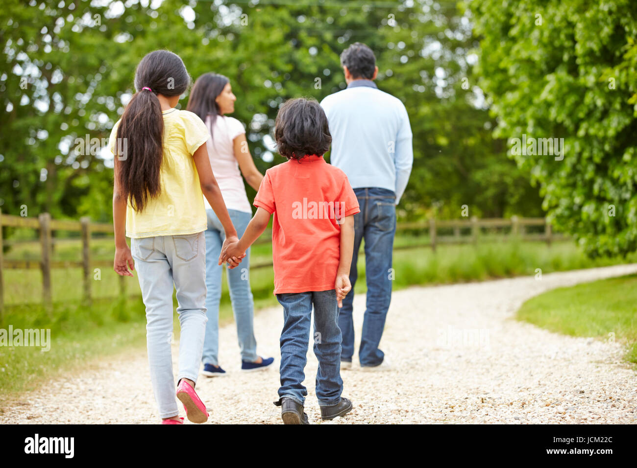 Indian Family Walking In Countryside Stock Photo