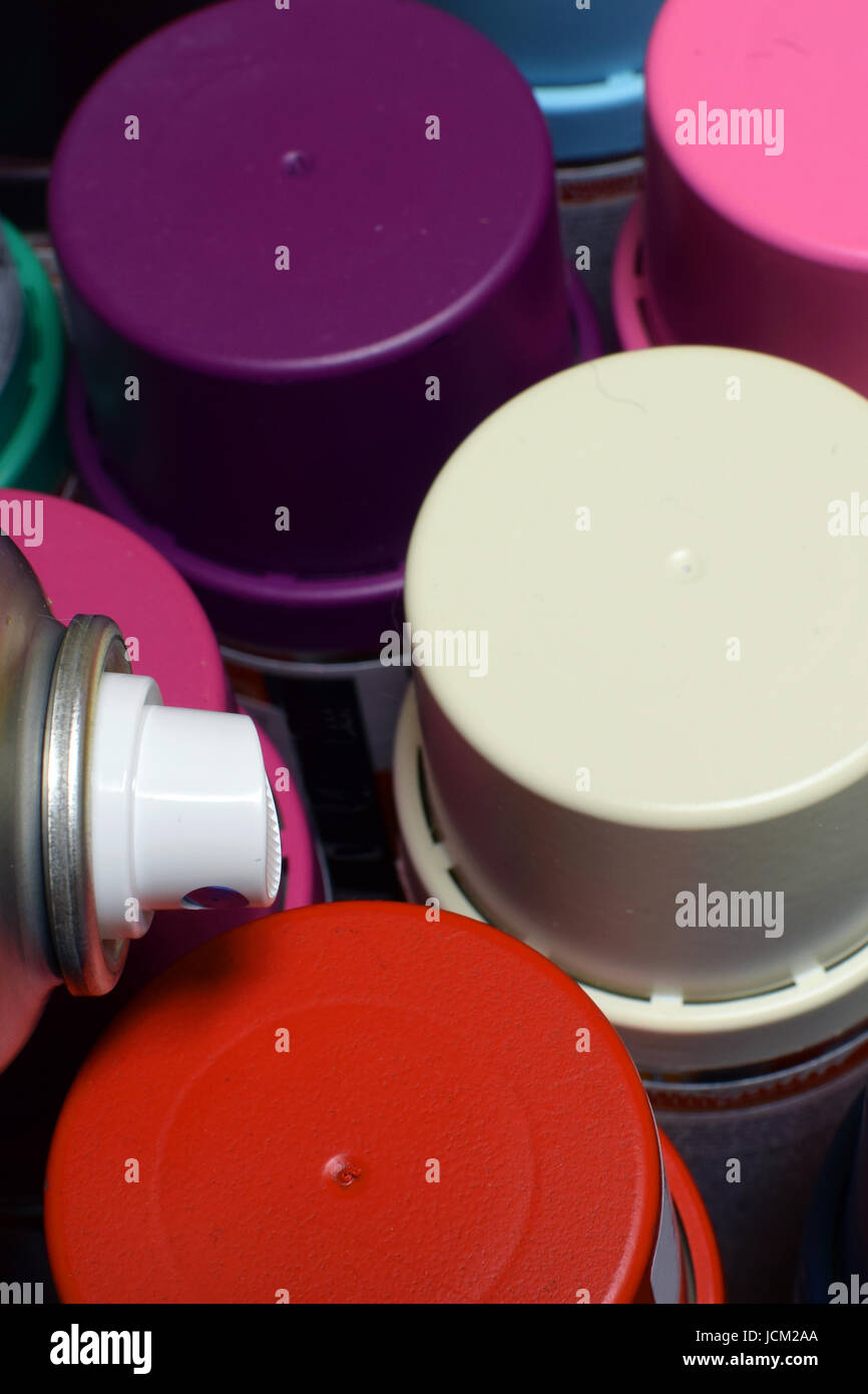 New spray paint cans. Top view vertical image. Stock Photo